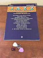 Front cover of the sheet music and three guitar picks