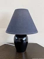 Full view of lamp with shade on tabletop