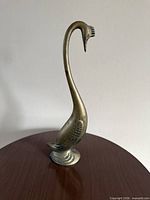 Full view brass swan on tabletop