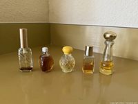 Front view of five mini perfume bottles lined up