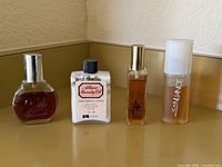 Front view of four vintage perfume/lotion bottles