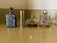 Front view of four vintage perfume bottles