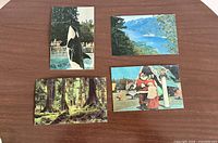 Fronts of four vintage postcards on table