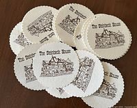Group of round Steinbeck House coasters on table
