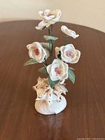 Full view of seashell floral sculpture on tabletop