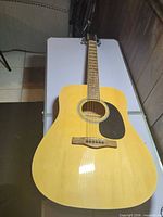 Full front view of Rogue RD80 acoustic guitar on table
