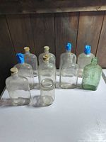 Ten glass containers grouped on table