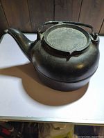 Cast iron kettle side view showing spout, lid, handle