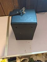 Top view of black steel console safe showing lock and key