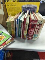 Side view of all cookbooks standing on table