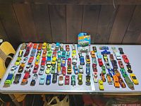 Full table view of all loose die-cast cars and one blister pack