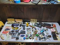 Overview of entire junk drawer lot on table