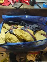 Tent fabric and poles in blue carry bag