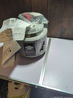 Overall view of PetSafe Wireless Instant Fence transmitter with paperwork on top