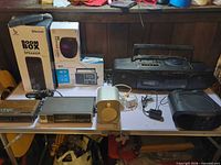 Group shot of all radios, speakers and stereo components on table