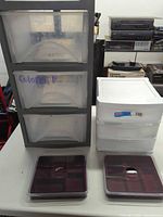 All plastic storage items together: gray 3-drawer unit, white 2-drawer unit, two square organizers