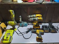 Full view of all power tools and chargers on tabletop