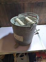 Front view of galvanized mop bucket with handle and foot pedal