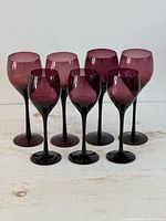 Group shot of all seven purple wine glasses
