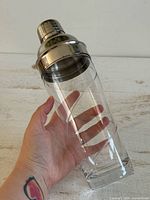 Cocktail shaker assembled, held in hand to show size and clarity of glass
