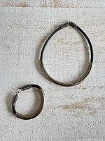 Necklace and bracelet laid flat showing overall design and size relation