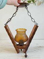 Full view of hanging lamp showing chain, canopy, wood brace, amber glass shade