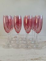 Front group view of all twelve pink and clear champagne flutes