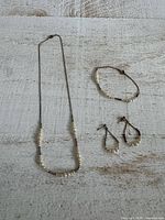 Full view of necklace, bracelet and earrings