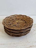 Stack of six round woven rattan baskets side view