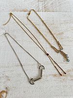 All three necklaces laid flat to show overall styles and colors