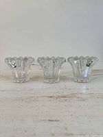 Front view of three identical clear bubble glass candle holders
