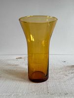 Full view of amber fluted glass vase standing upright