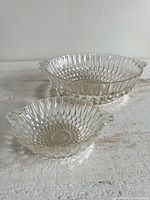 Two clear glass bowls, different sizes, hobnail pattern bases, ribbed sides, tab handles