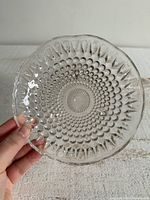 Top view of clear glass dish showing teardrop hobnail pattern and scalloped rim