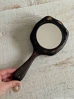 Front view of black wooden hand mirror