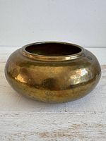 Front angled view of hammered brass planter pot