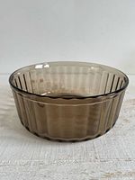 Top view of round brown smoky glass dish showing ribbed sides and clear base