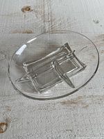 Top view of clear oval divided dish showing square pattern and four sections
