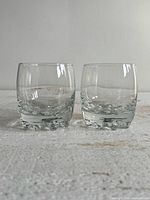 Two clear glass whiskey tumblers side by side