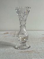 Full view of clear cut crystal bud vase standing upright