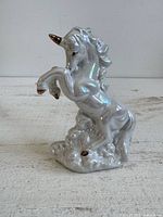 Front left view of iridescent lusterware unicorn figurine