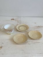 Group shot of teapot and three saucers