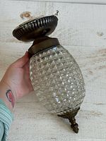 Overall view showing glass pineapple shade, canopy and finial