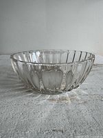 side view of ribbed clear glass bowl showing profile and rib pattern