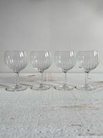 Four short wine glasses lined up, showing overall design