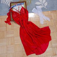 Full view of red satin slip dress laid flat showing length and slit