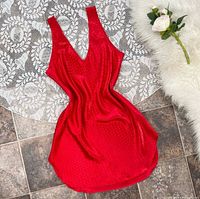 Front view of ruby red satin polka-dot slip dress laid flat