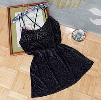 Full view of black velvet jacquard slip dress laid flat