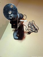 Full view of vertometer lensometer showing frame, base, and power cord