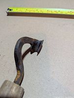 Close-up of curved iron blade showing patina and shape